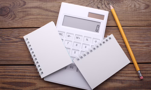 Image of a calculator and two pads, to represent spousal maintenance payments.